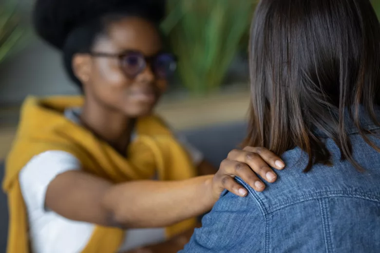 Moral support and mental health, african american woman supporting a colleague in a difficult situat